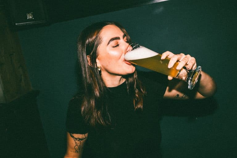 Woman drinking a pint of IPA